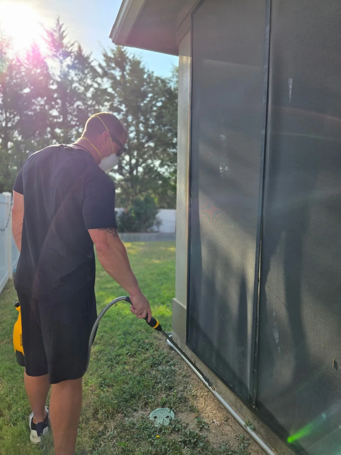 Bug Lock treating the foundation edge and lower perimeter of a North Texas home